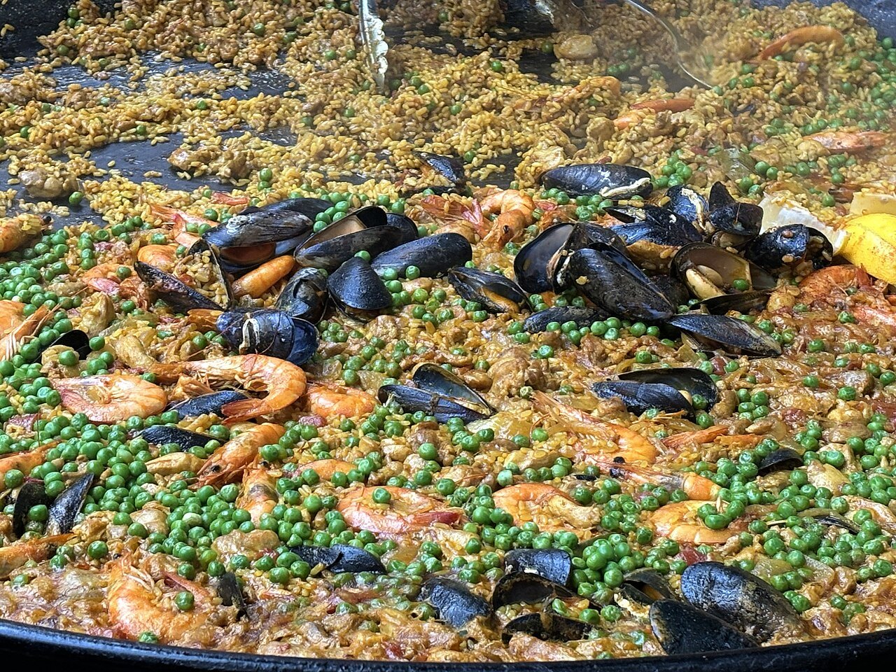 Mussels, prawns and peas in a pan of paella at Borough Market