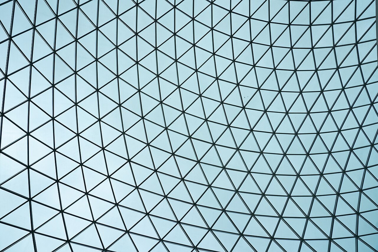 The steel and glass lattice of the Great Court roof seen from below