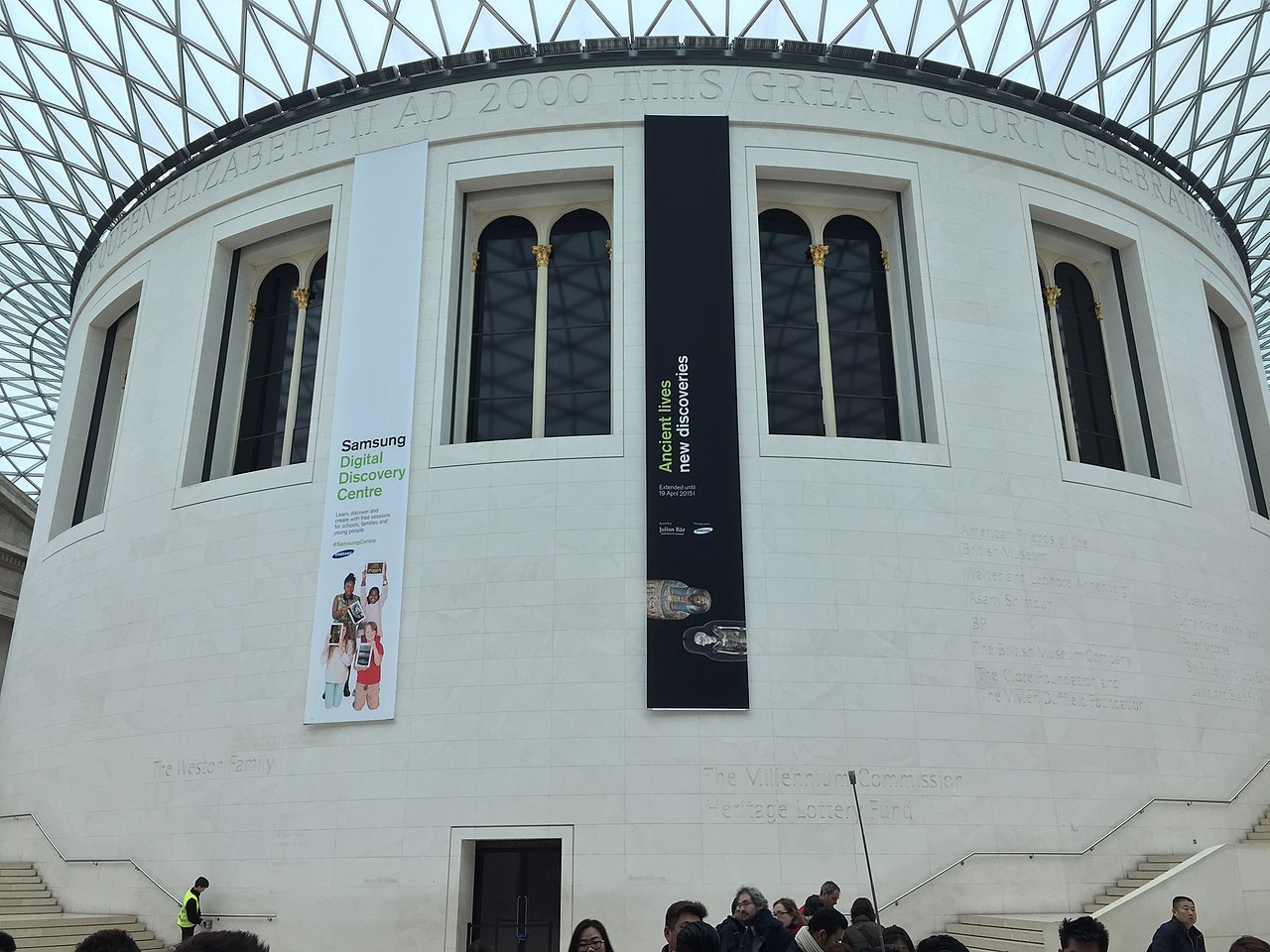 The white drum of the Reading Room in the British Museum's Great Court, with banners hanging on its side