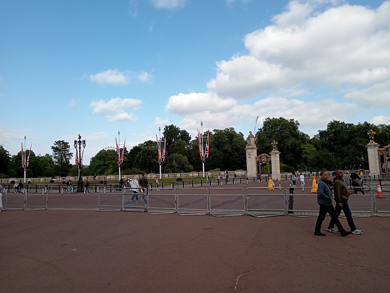 Flags along the Mall and the gates at the far end of the red roadway before the palace