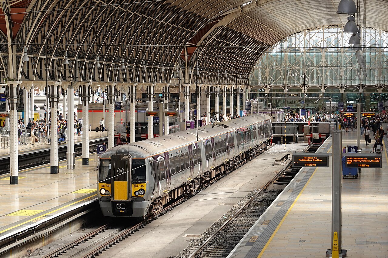 A Heathrow Express train at a Paddington platform under the glass and iron roof