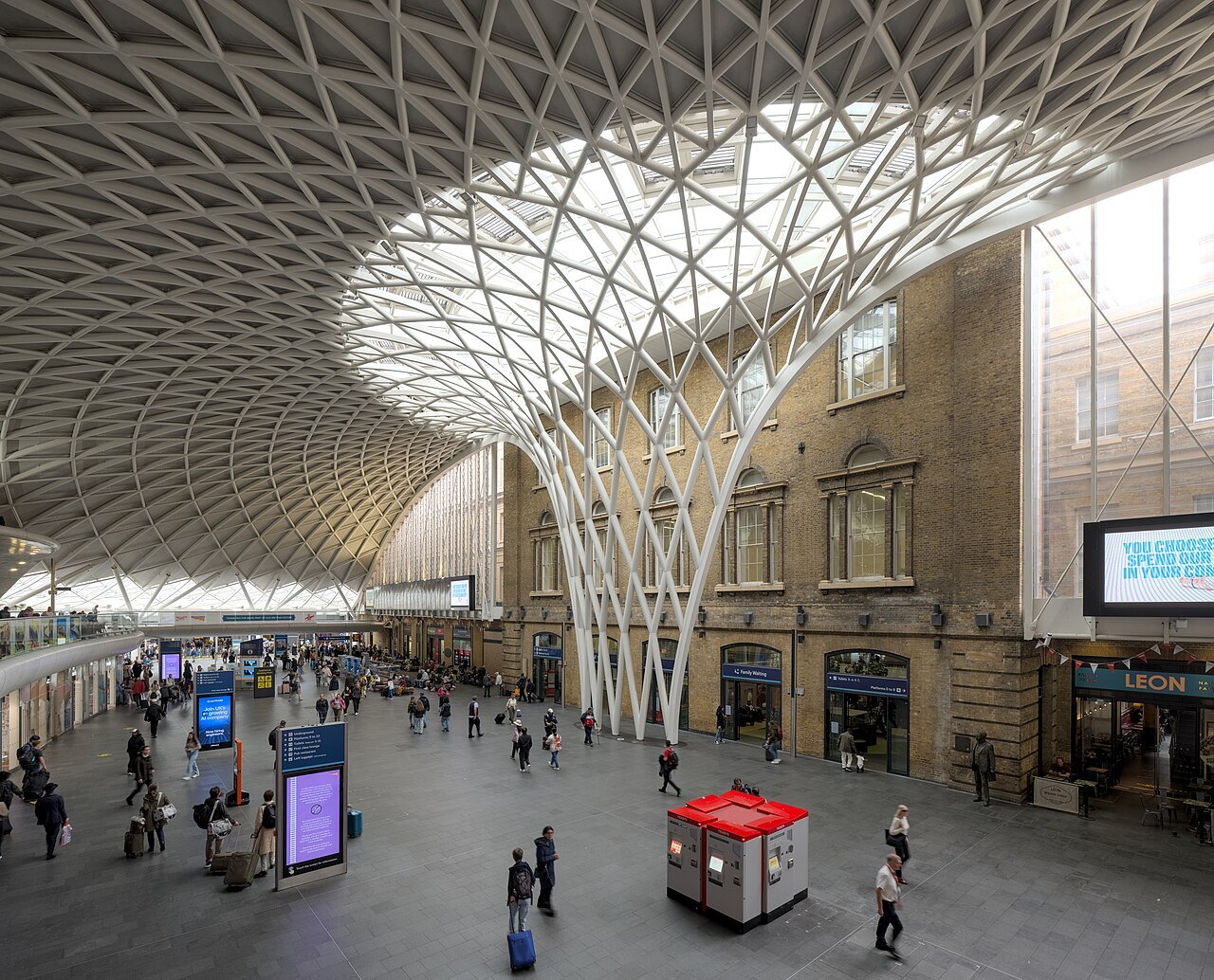The western concourse of King's Cross station, its white lattice roof rising from a central column