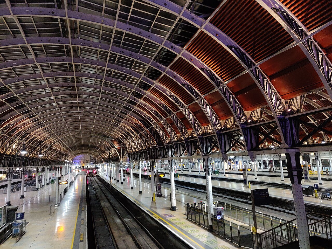 The arched iron roof of Paddington station over platforms seven and eight, from a footbridge