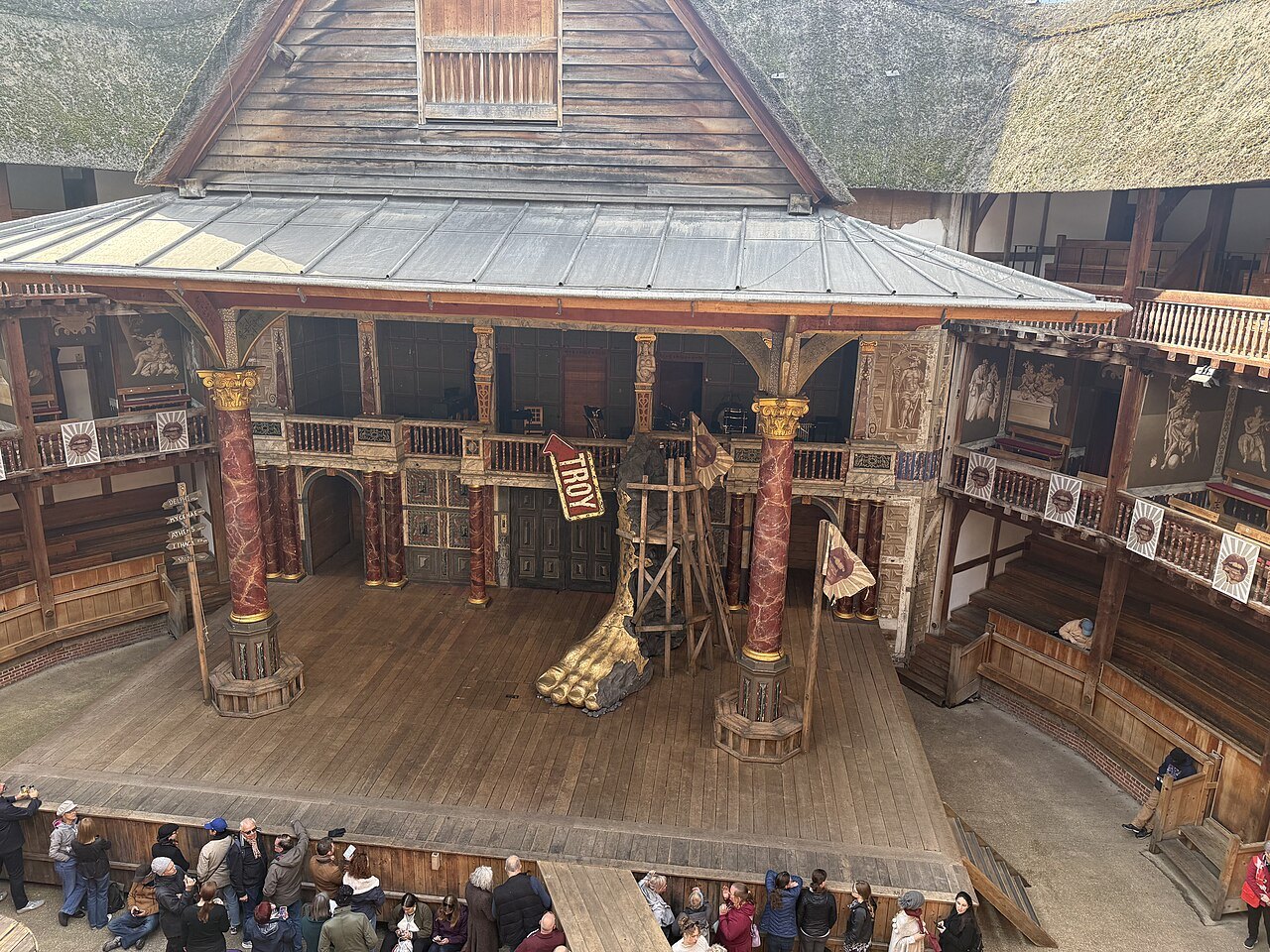 The stage of Shakespeare's Globe, with its painted columns and the thatched roof of the stage cover