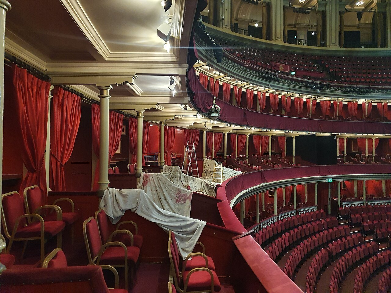 Empty red seats and curtains in a box at the Royal Albert Hall