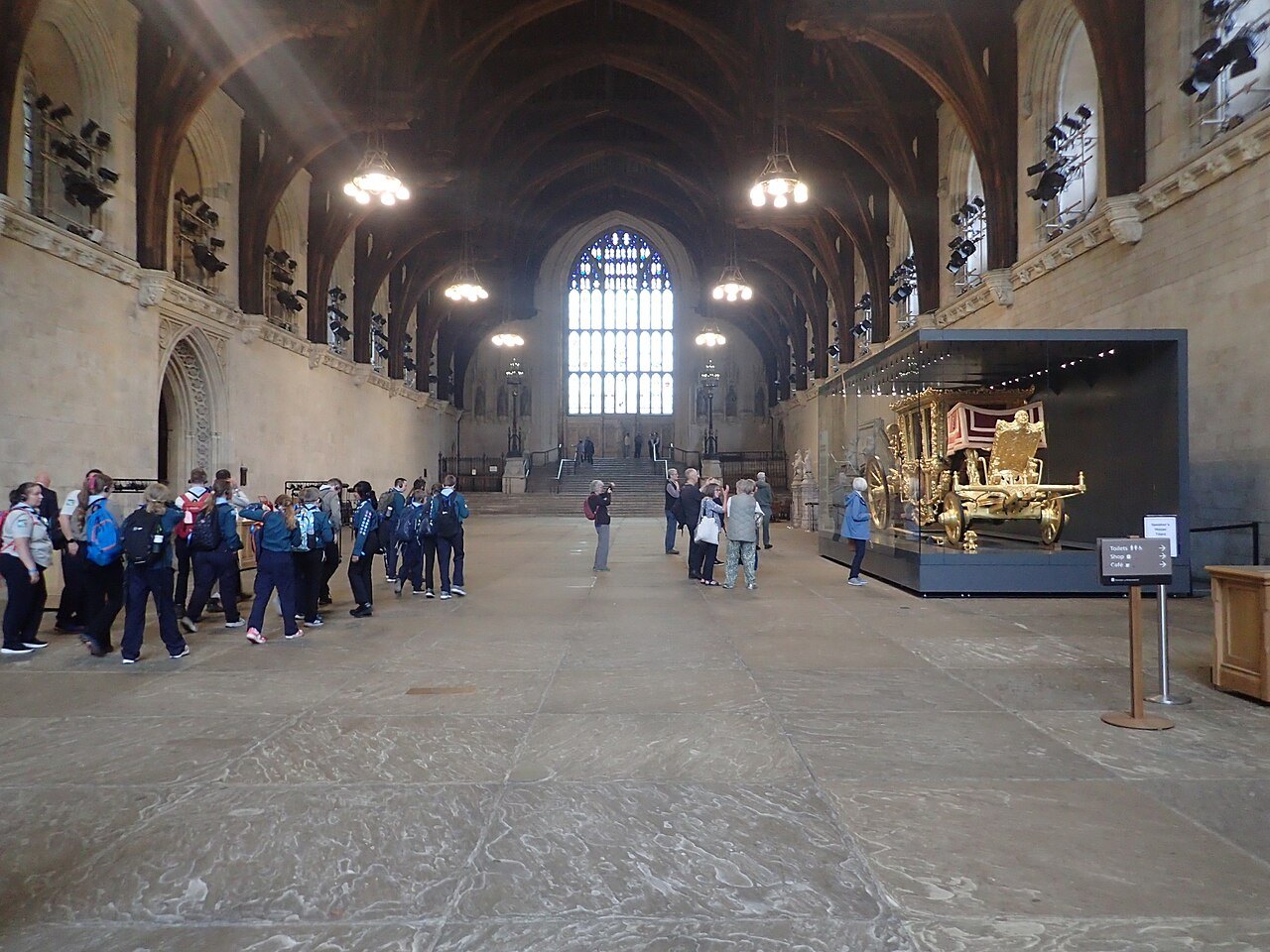 Westminster Hall, with its great timber roof, a school party in the nave and an exhibit at the right