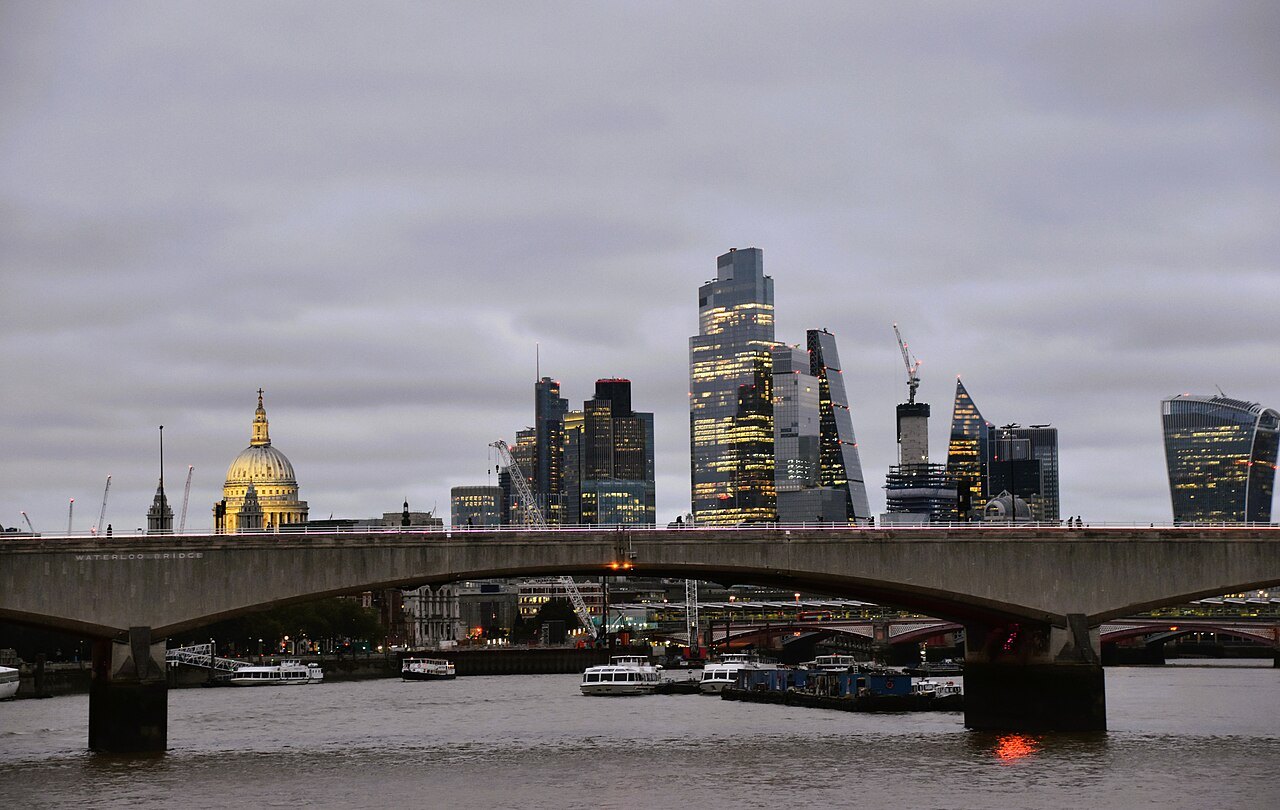 Waterloo Bridge and the dome of St Paul's with the City's towers beyond, under a grey sky