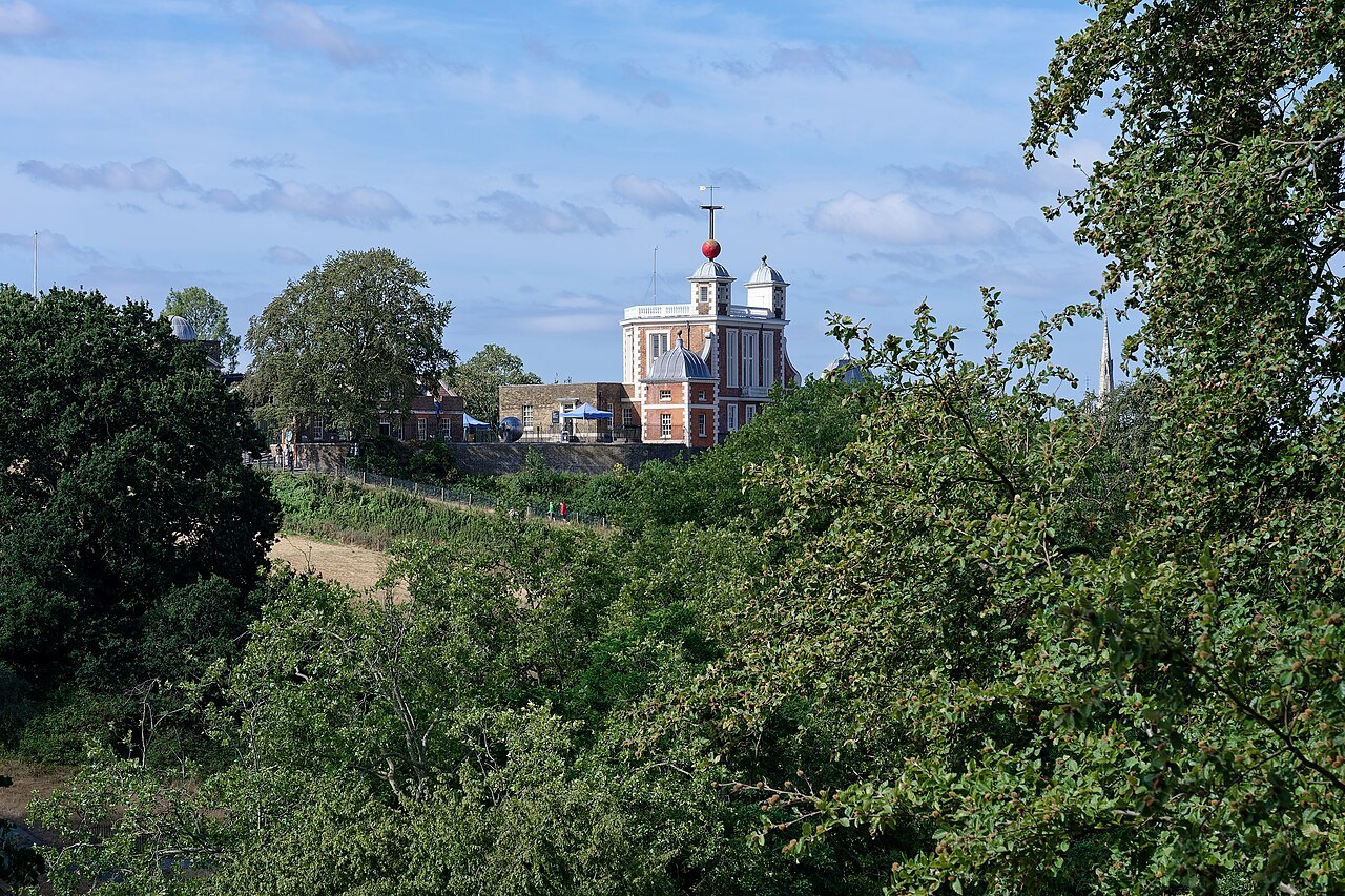 The Royal Observatory on its hill, seen from One Tree Hill across the leaves in Greenwich Park