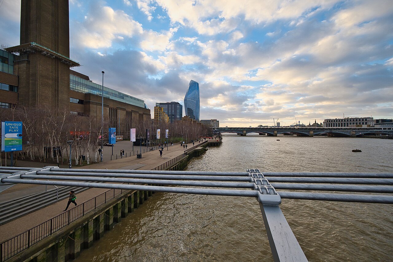 The river path along the Thames below Tate Modern, with the Millennium Bridge's rail at the front
