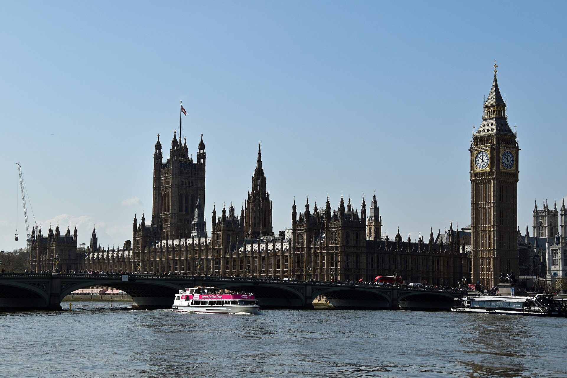 Westminster Bridge and the Palace of Westminster across the river, with a tour boat in front