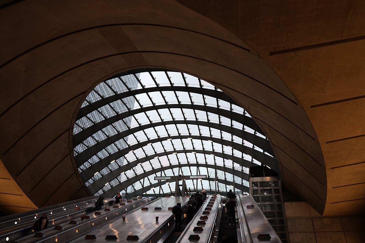 The curved timber and glass vault over an escalator shaft at Canary Wharf Underground station