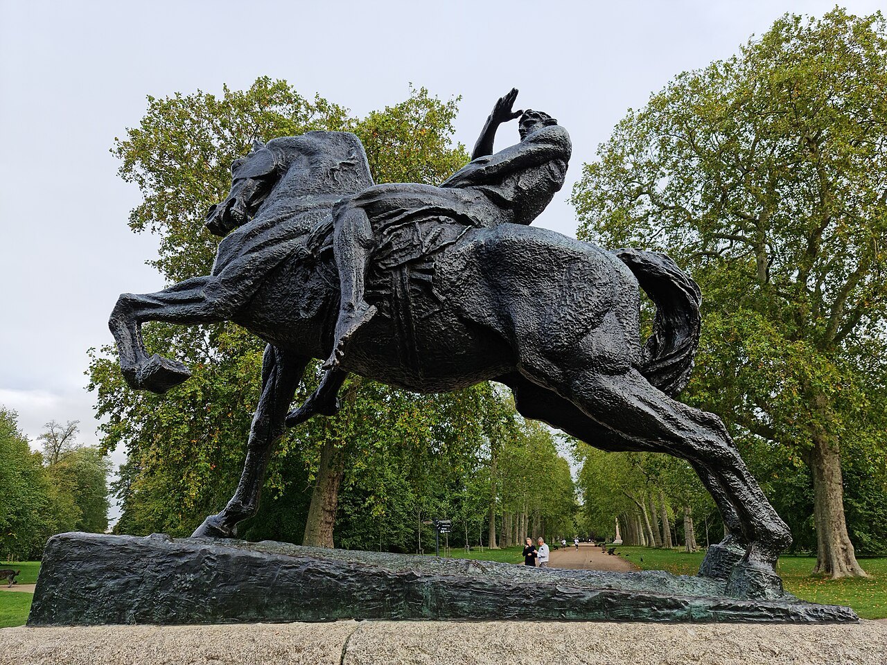 Physical Energy, the bronze horse and rider, standing on its stone plinth among the trees of Kensington Gardens