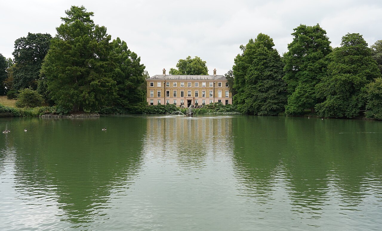 Kew Palace beyond the lake, seen through the trees