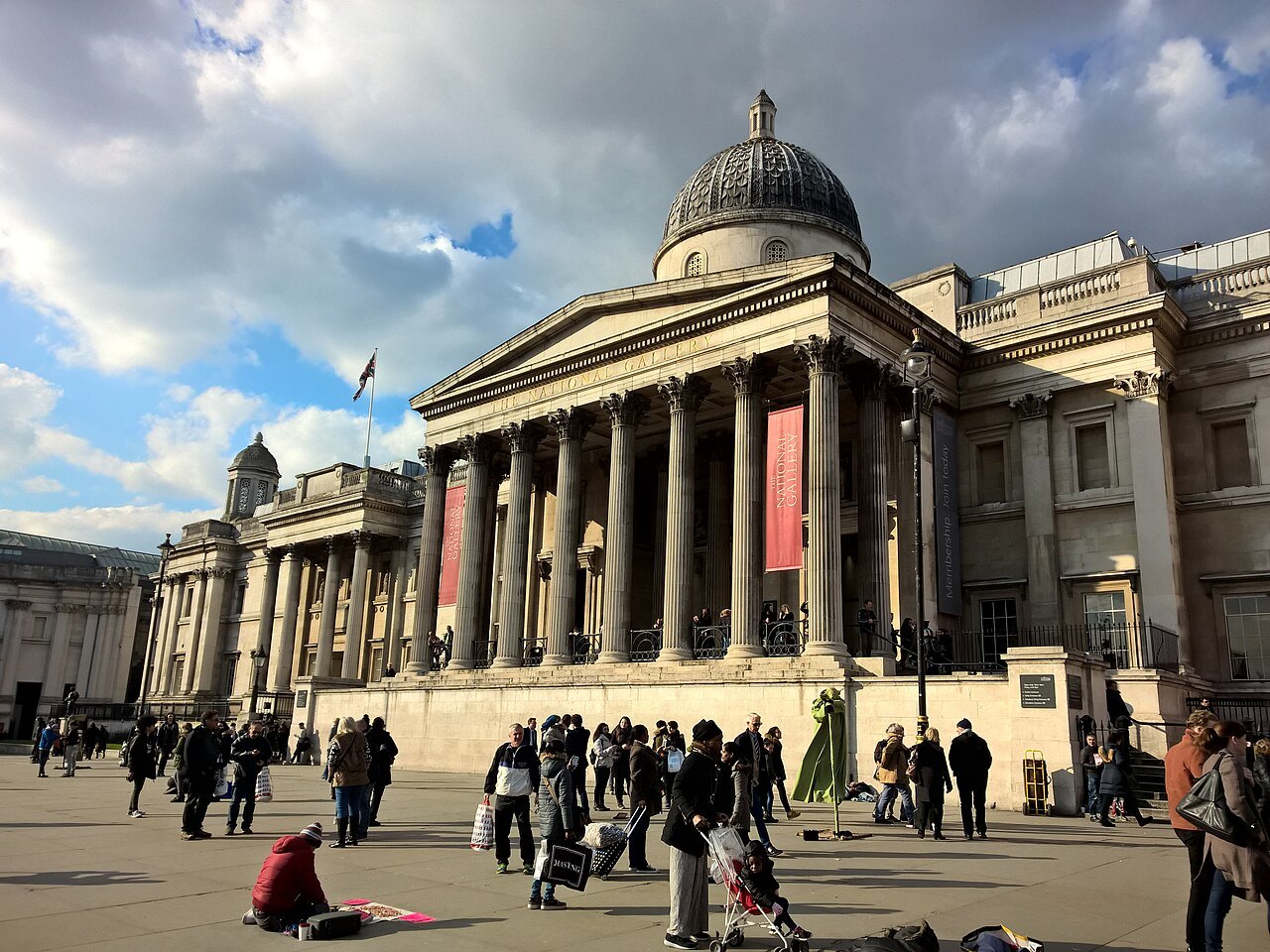 The National Gallery's portico above Trafalgar Square, with a crowd of visitors on the steps