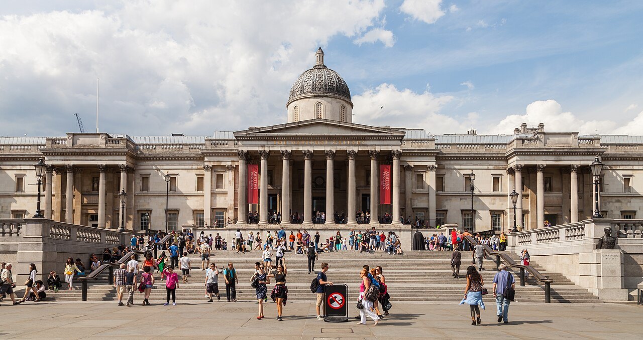 The long front of the National Gallery above wide steps, with visitors sitting and walking