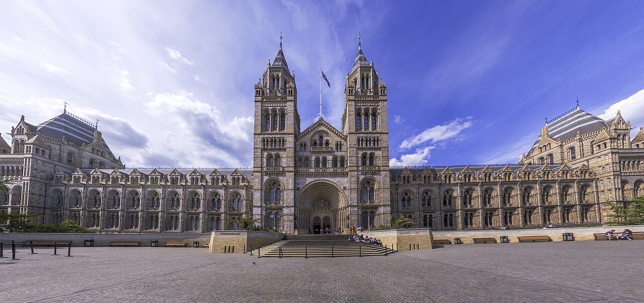The Natural History Museum's long front across an empty paved forecourt