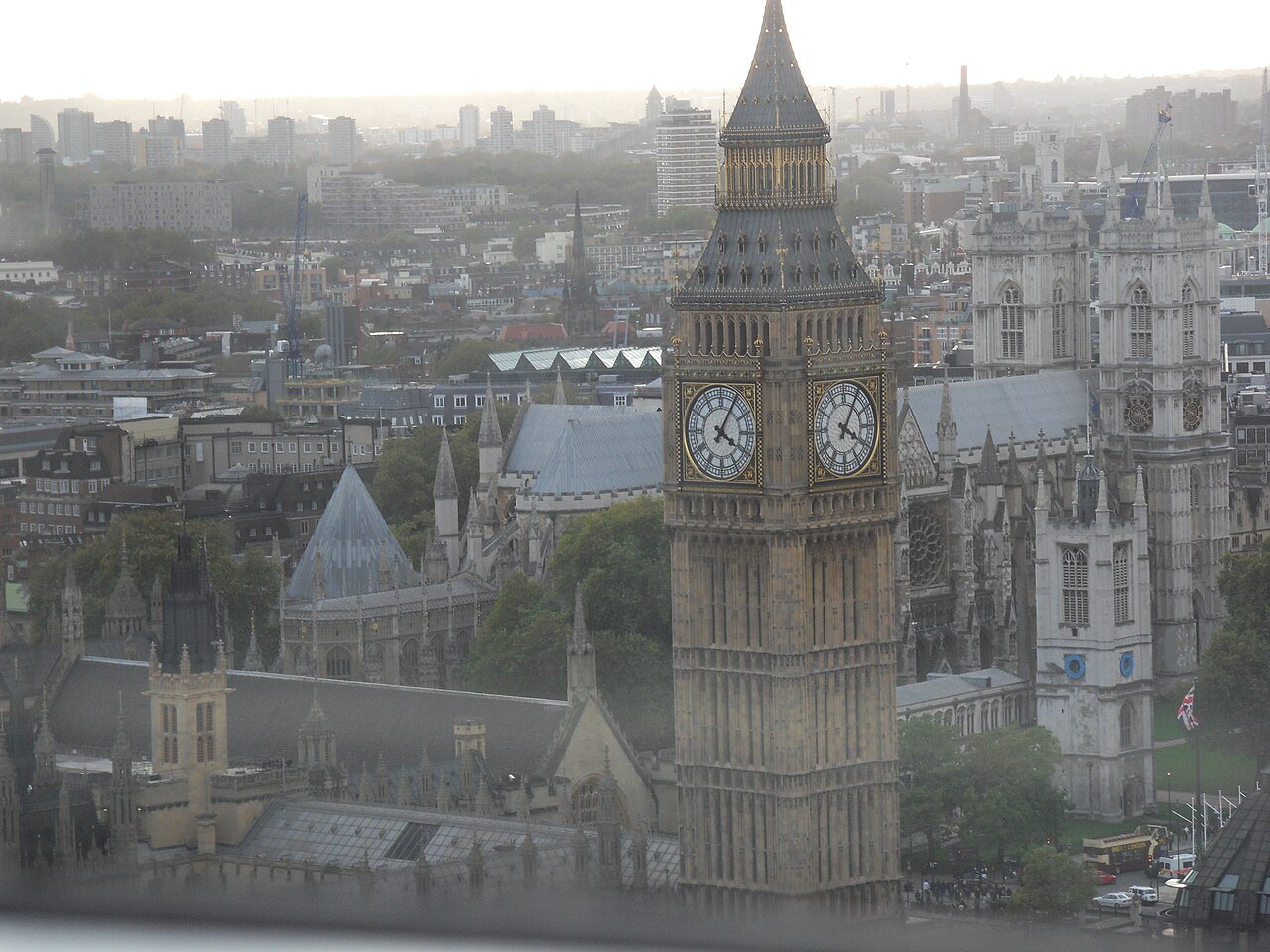 The Elizabeth Tower rising above the rooftops, seen from a height in a soft haze
