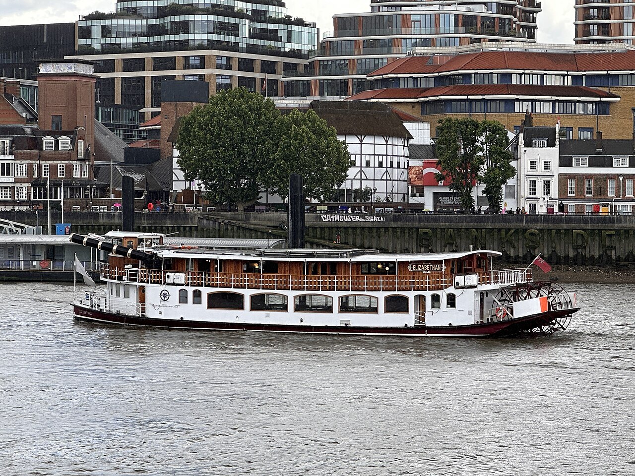 A paddle-style river boat passing the Globe's roof and the buildings of Bankside across the water