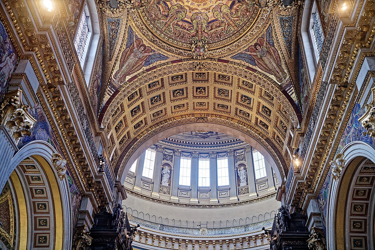 A vaulted bay beneath the dome of St Paul's, richly panelled and gilded, with a window at the top