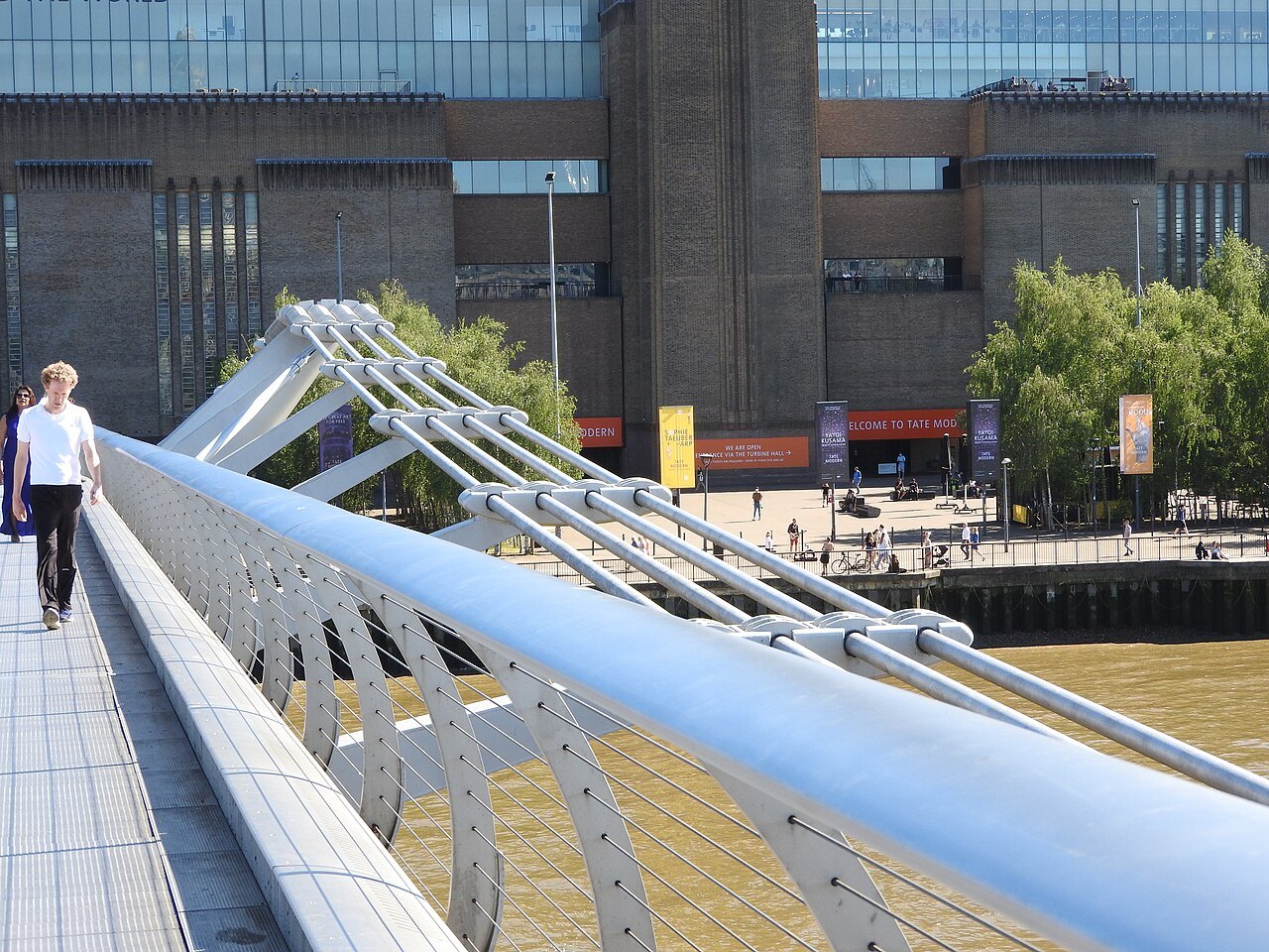 Looking along the rail of the Millennium Bridge toward the front of Tate Modern