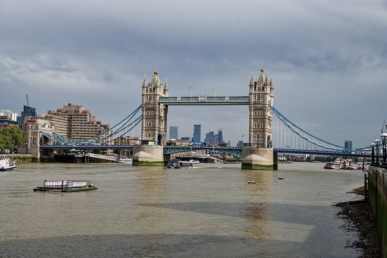 Tower Bridge with its high walkways, seen across the Thames at low tide