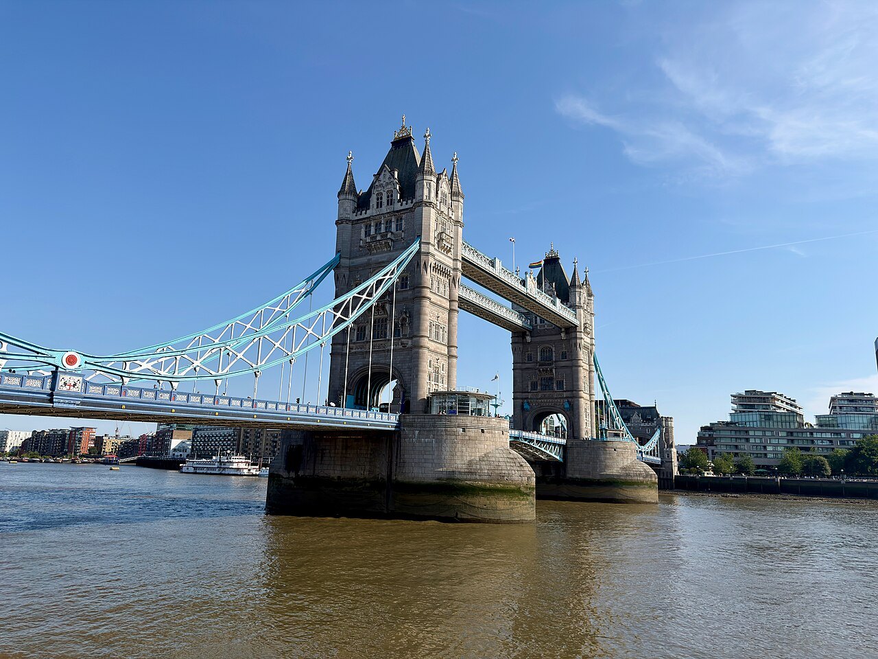Tower Bridge seen from the river wall with a clear sky above