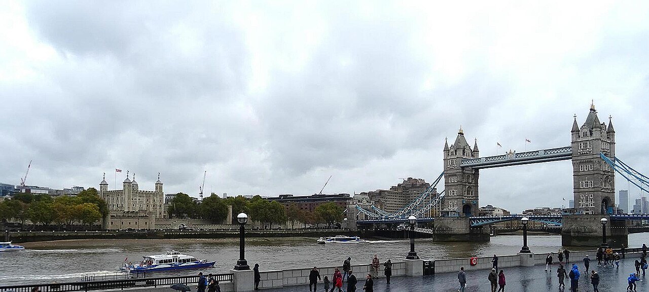 Tower Bridge and the Tower of London on the far bank, seen along the river from the south