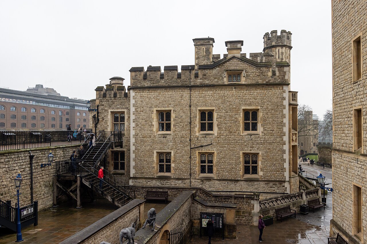 A castellated stone building inside the Tower's walls, with steps leading down beside it