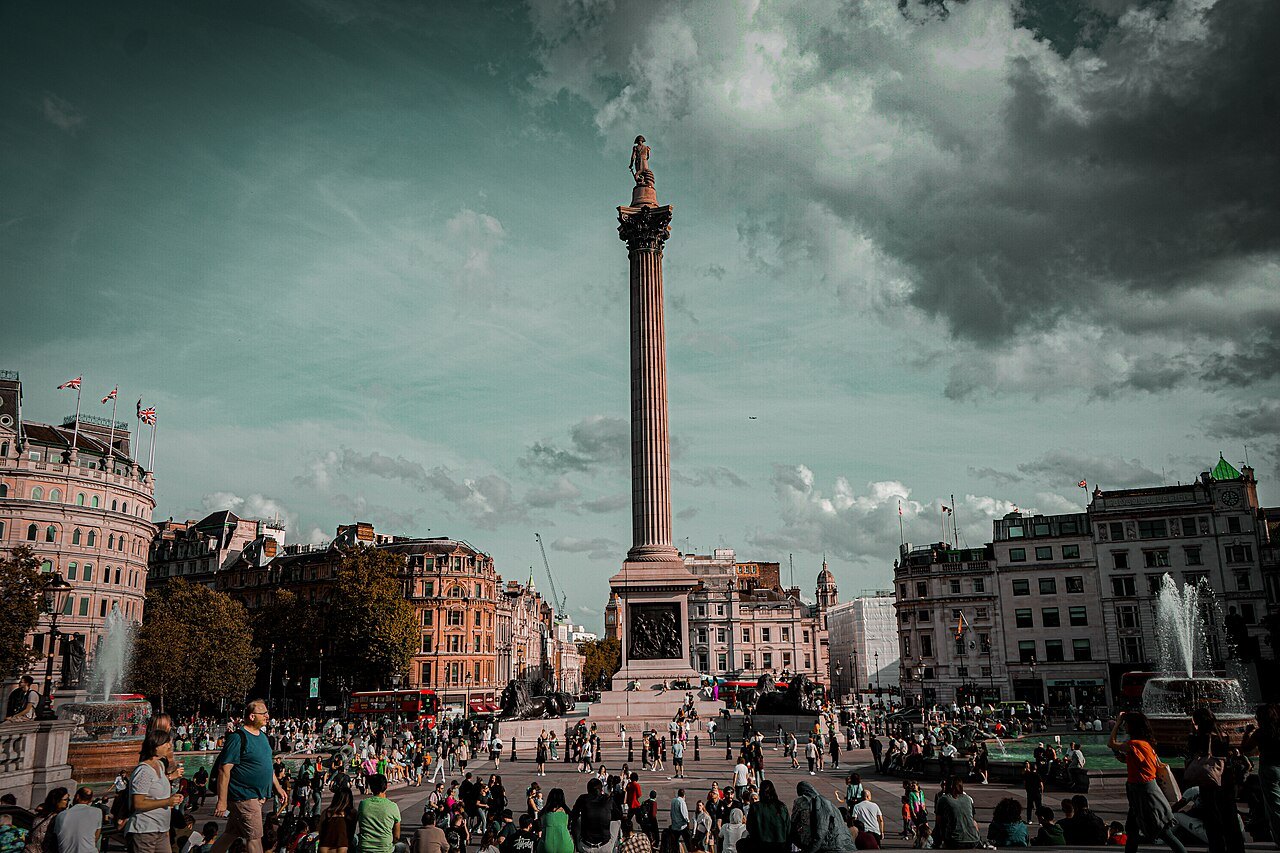 Nelson's Column and the crowds of Trafalgar Square under a dramatic sky