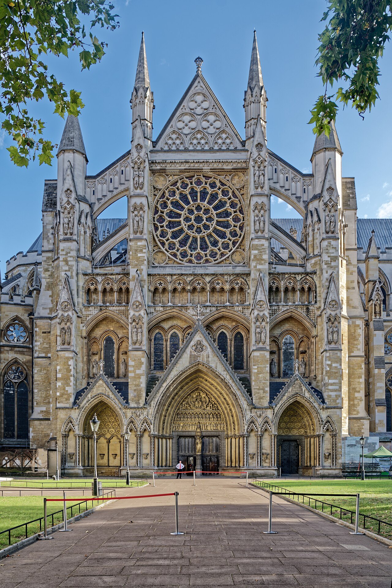 The north front of Westminster Abbey, with its rose window and the gabled porch seen along a path