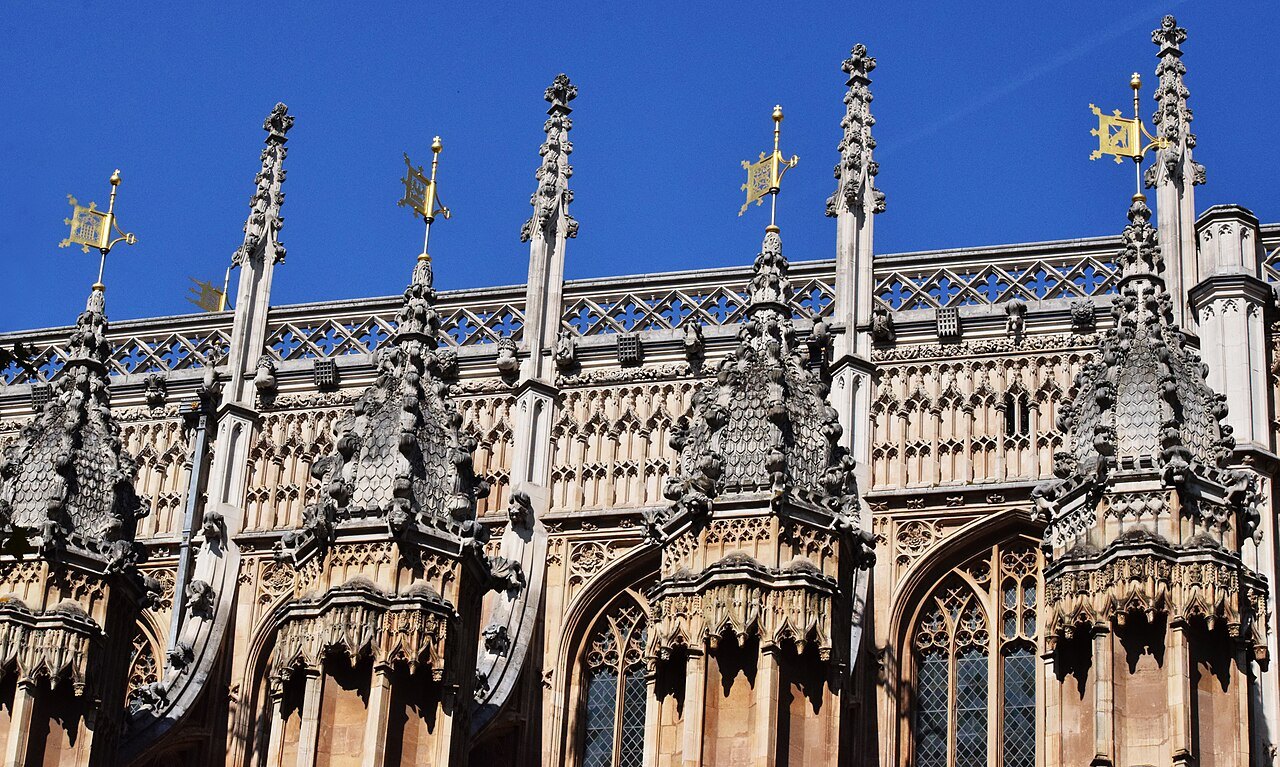 The pinnacles and flying buttresses of the Henry VII Chapel against a deep blue sky