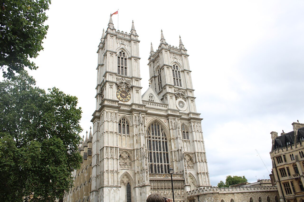 The twin towers of Westminster Abbey's west front, seen between trees