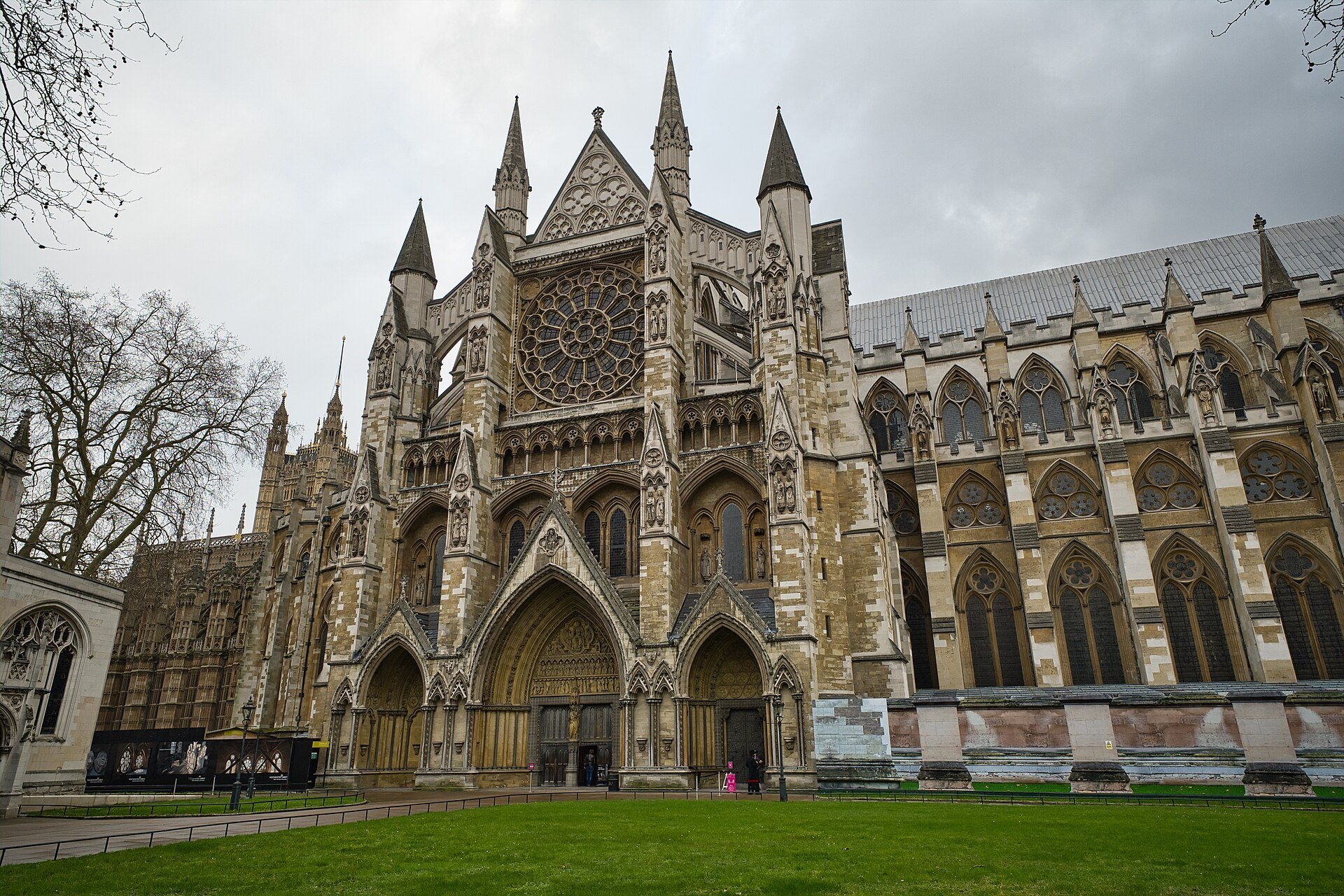 The north front of Westminster Abbey, its pointed porch and rose window above a green lawn