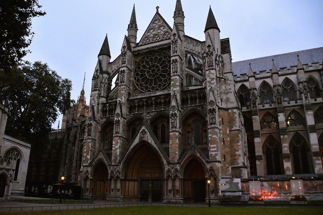 The north front of Westminster Abbey with its three pointed doorways, at dusk